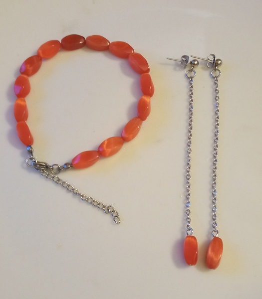 She'll bead bracelet and chain drop earrings