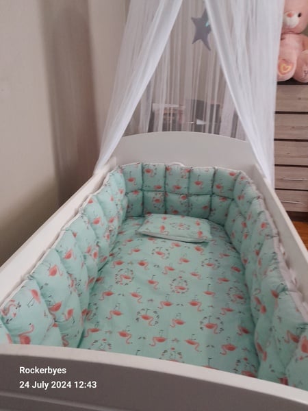 Pink stuffed cot bumper  and cot duvet