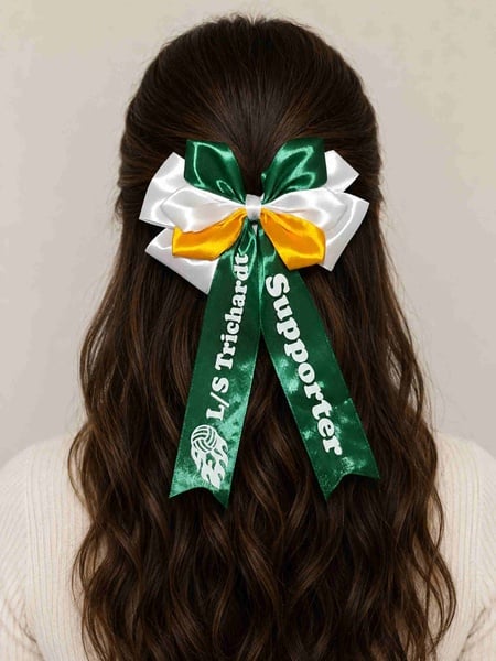 Brunette woman viewed from behind wearing a green, white and gold custom printed supporter bow against a soft neutral background.