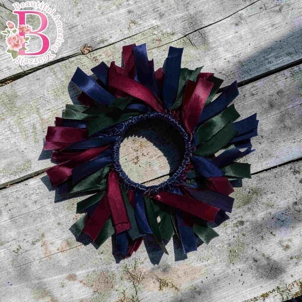 Handmade maroon, navy blue and bottle green ribbon hair scrunchie on a rustic wood background, ideal for school or everyday wear.