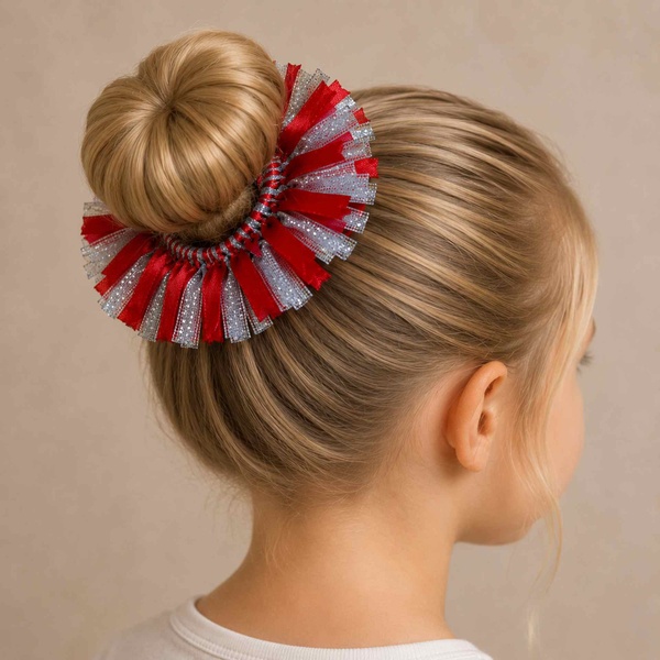 Blonde girl's bun viewed from the back right with a red and silver ribbon scrunchie hair accessory on a soft neutral background.