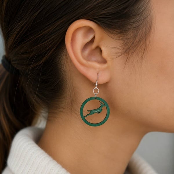 SA Springbok Rugby green hoop earrings with springbok design worn on ear, handmade with hypoallergenic hooks, close-up lifestyle photo.