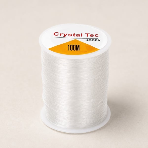 Crystal Tec Korea 100m clear elastic beading thread spool on a neutral background for jewellery making, bracelets, crafts and DIY.