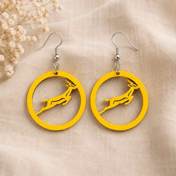 Yellow Springbok rugby earrings with hypoallergenic hooks on soft beige linen background, lightweight handmade South African jewellery.