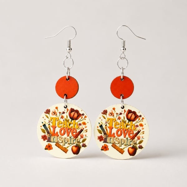 Teacher-inspired handcrafted dangle earrings with warm orange accents on a soft neutral background, ideal for thoughtful gifting.