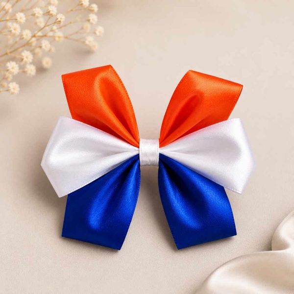 Orange, white and blue satin hair bow with a white center band, beautifully displayed on a soft neutral backdrop for online product listing.