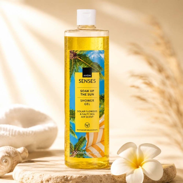 Avon Senses Soak Up the Sun Shower Gel 500ml on a warm spa-inspired background with soft sunlight, seashells and tropical flower.