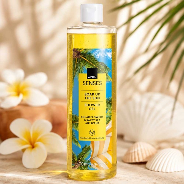 Avon Senses Soak Up the Sun Shower Gel 500ml on a tropical spa-inspired background with flowers, seashells and soft natural light.