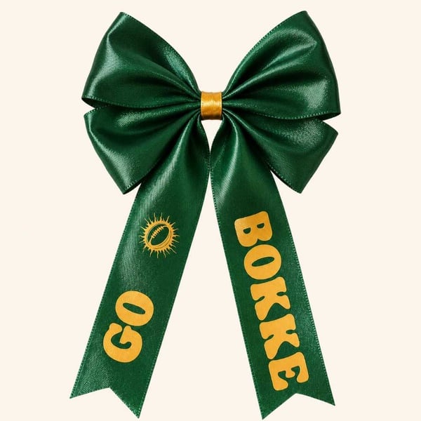 Emerald green Go Bokke satin hair bow with gold print on a warm neutral background, centered for Google Shopping product display.
