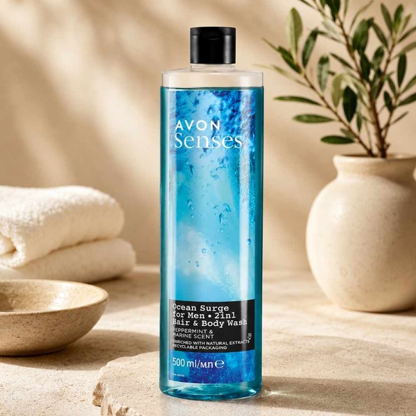 Avon Senses Ocean Surge 2-in-1 Hair & Body Wash 500ml on a warm neutral spa-inspired background with towels and greenery.